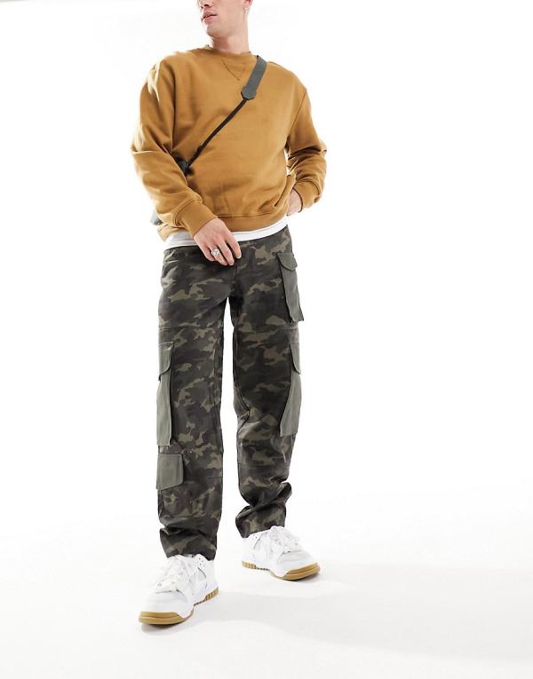 ASOS DESIGN baggy cargo pants in all over camo print with contrast pockets and panelled detail-Green