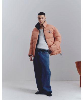 Calvin Klein Jeans reversible 90s puffer jacket in orange-Black