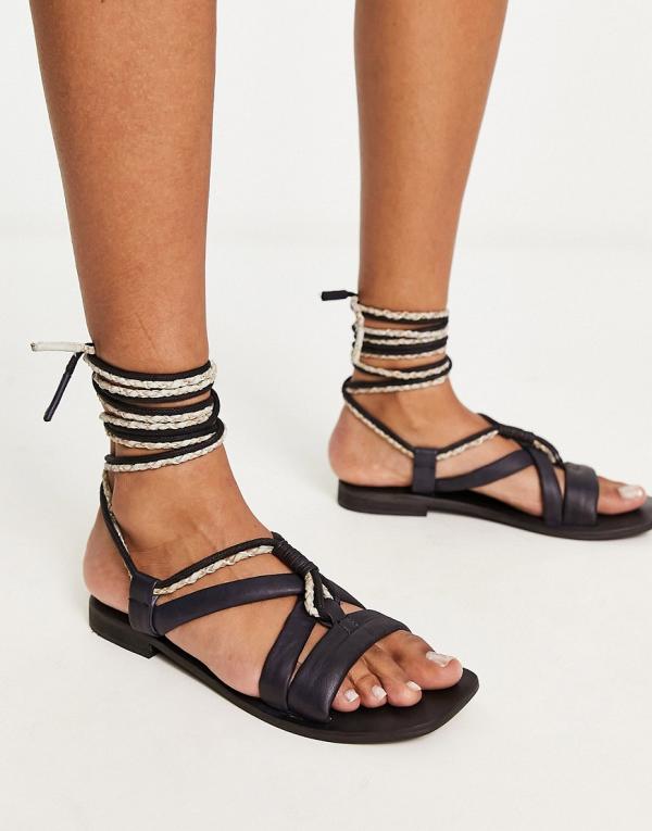 Free People leather wrap sandals in black and cream