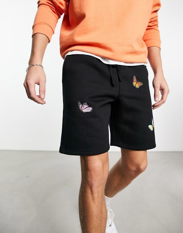Good For Nothing jersey shorts in black with butterfly placement prints