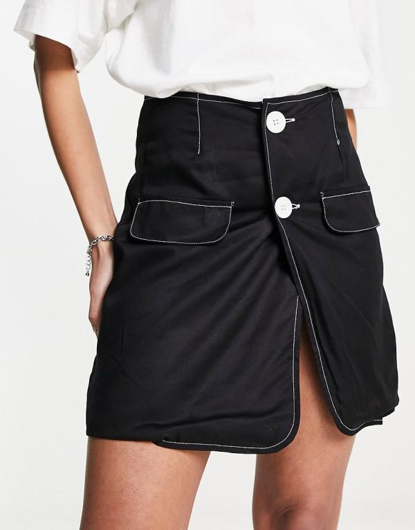 Heartbreak button front mini skirt with contrast stitch in black