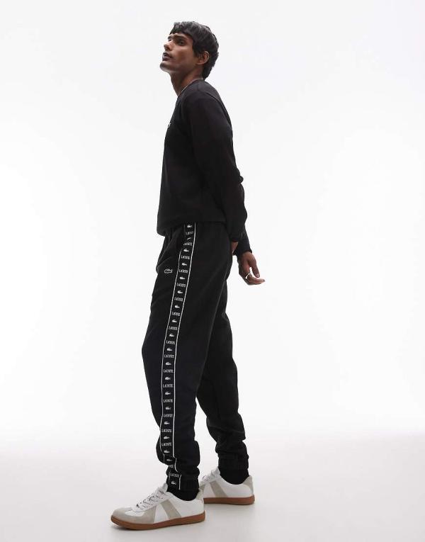 Lacoste logo stripe trackies in black