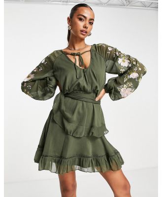 ASOS DESIGN blouson sleeve tiered mini dress with cross stitch embroidery detail and tie in khaki-Green