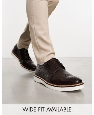 ASOS DESIGN brogue shoes in brown leather on white wedge sole