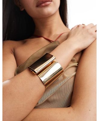 ASOS DESIGN cuff bracelet with folded detail in gold tone