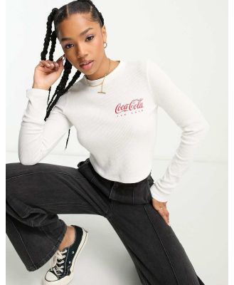 ASOS DESIGN long sleeve waffle baby tee with Coca-Cola licensed graphic in cream-White