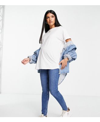ASOS DESIGN Maternity ultimate skinny jeans in authentic mid blue with under the bump waistband