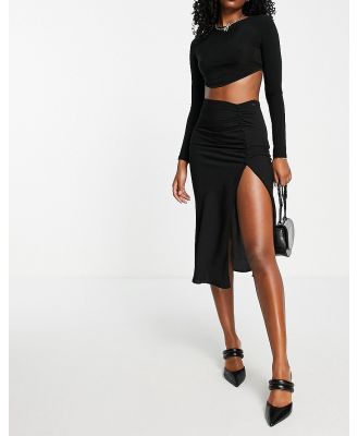 ASOS DESIGN midi skirt with ruched side and button detail in black
