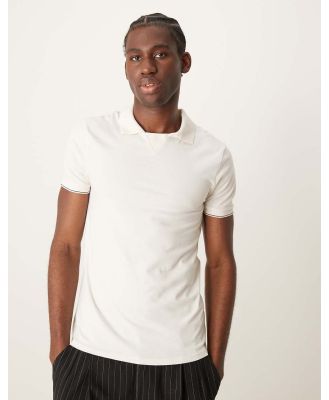 ASOS DESIGN muscle fit polo with revere collar in cream-White