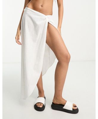 ASOS DESIGN natural asymmetric beach skirt with twist front in white