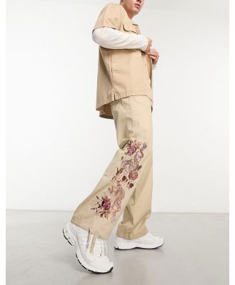 ASOS DESIGN parachute pants with dragon embroidery in washed stone-Neutral