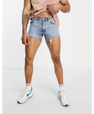 ASOS DESIGN shorter length denim shorts in 90s mid wash with rip detail and raw hem-Blue