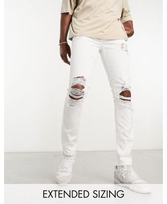 ASOS DESIGN skinny jeans with heavy rips in white