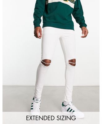 ASOS DESIGN spray on jeans with power stretch in white with rips