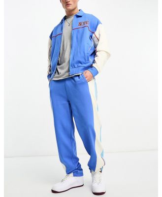 ASOS DESIGN straight leg trackies in blue colour block (part of a set)