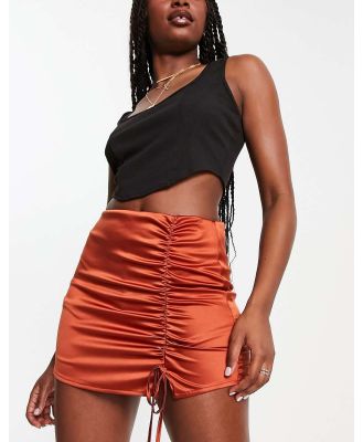 ASOS DESIGN stretch satin ruched skort in rust-Red