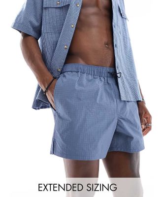 ASOS DESIGN swim shorts in short length in blue with bungee cord