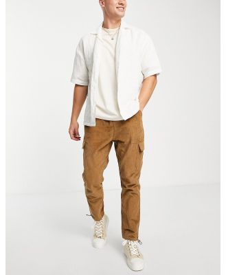 ASOS DESIGN tapered cargo pants in cord in brown