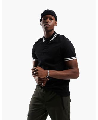 ASOS DESIGN tipped pique polo shirt in black