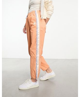 Aape By A Bathing Ape college parachute pants in orange