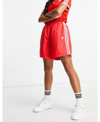 adidas Originals adicolor Three-Stripes long length shorts in red