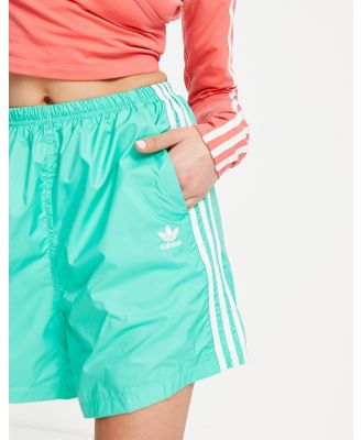 adidas Originals adicolour three stripe long shorts in green-Blue