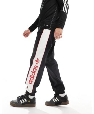 adidas Originals linear logo trackies in black, white and red