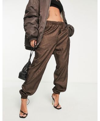 adidas Originals Luxe Lounge repeat logo woven trackies in brown