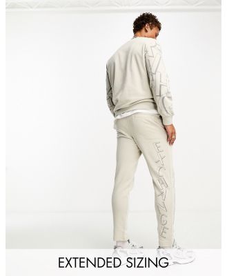 Armani Exchange scattered logo trackies in light beige mix and match-Neutral