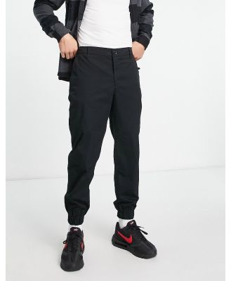 Armani Exchange tapered elastic waisted pants in black