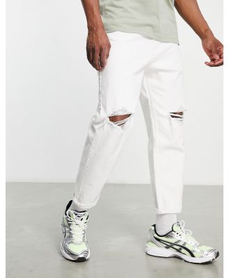 Bershka tapered jeans with rips in white-Blue