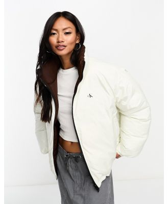 Calvin Klein Jeans reversible 90s puffer jacket in white/brown