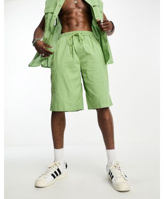 COLLUSION linen beach shorts in light green