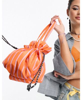 Damson Madder drawstring grab bag in orange and lilac stripe