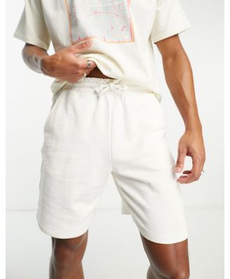 Fila jersey shorts with back pocket print in ecru-White