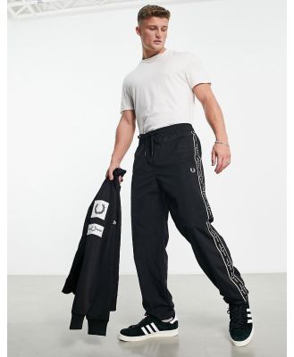 Fred Perry side taping shell trackies in black