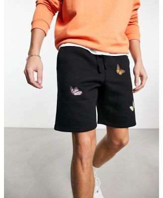 Good For Nothing jersey shorts in black with butterfly placement prints