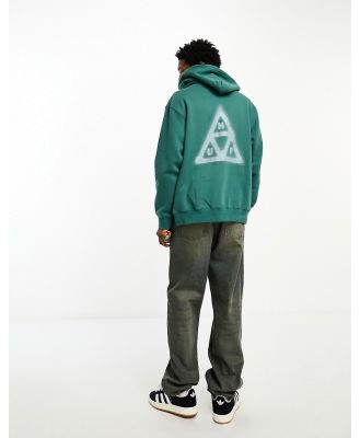 HUF Horus zip through hoodie in sage green with horus eye badge and triangle back print