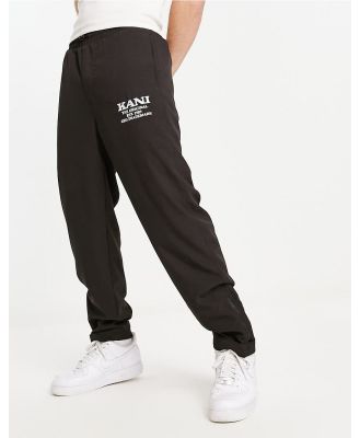 Karl Kani retro straight leg pants in black with zip hem detail