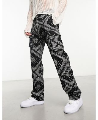 Karl Kani small signature cargo pants in black with all over paisley print