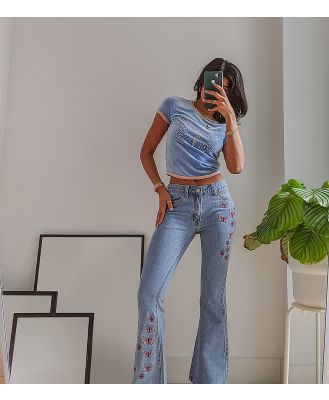 Labelrail x Pose and Repeat mid rise 90s flared jeans with butterfly appliques in blue