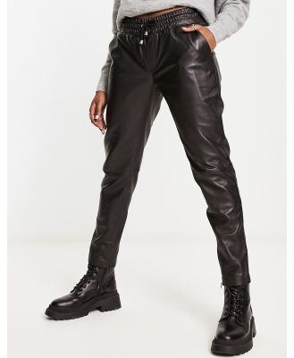 Muubaa tapered leather track pants in black