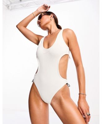 Nike Swimming Explore Wild cutout one piece swimsuit in cream-Neutral