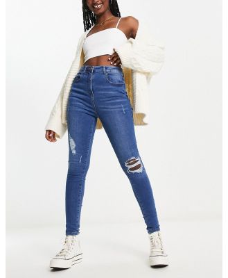 Parisian skinny jeans with rips in mid wash blue
