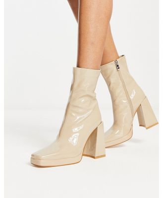 RAID Vista heeled sock boots in ecru vinyl-White