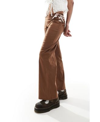 Reclaimed Vintage flare pants in brown with pink bows & ribbon