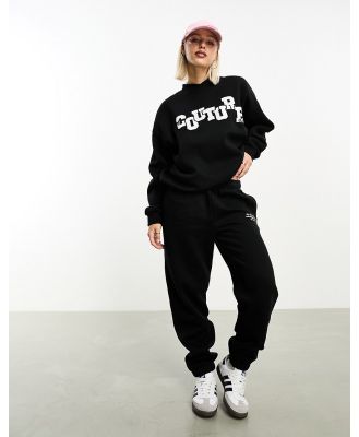 The Couture Club applique trackies in black