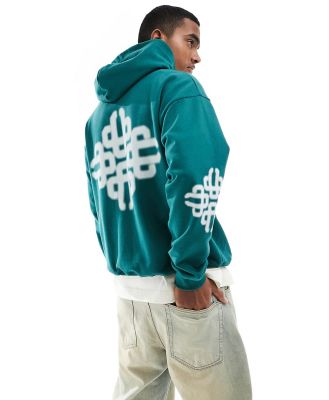 The Couture Club blurred emblem graphic hoodie in off green