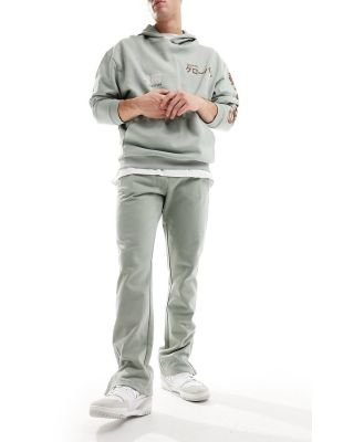 The Couture Club emblem trackies in khaki-Green