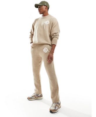 The Couture Club fluffy emblem knitted pants in beige-Grey